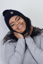 Load image into Gallery viewer, Navy Satin Lined Bobble Hat - Black Sunrise UK Satin Lined Hats,. Satin lined Beanie, Hoodies. For children, adults, babies. For those with curly natural hair, sensitive scalps and fragile curls.