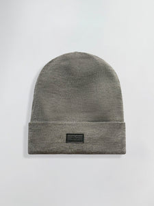 Gray Satin Lined beanie with a black label on a light gray background