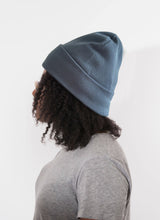 Load image into Gallery viewer, Person wearing a Satin Lined blue beanie and gray shirt on a white background
