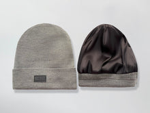 Load image into Gallery viewer, Gray beanie with a black Satin Lined interior and brand logo on a light gray background
