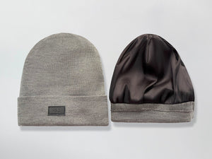 Gray beanie with a black Satin Lined interior and brand logo on a light gray background