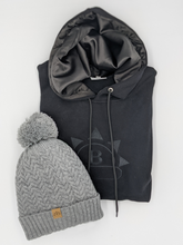 Load image into Gallery viewer, Grey Satin Lined Bobble Hat - Black Sunrise UK Satin Lined Hats,. Satin lined Beanie, Hoodies. For children, adults, babies. For those with curly natural hair, sensitive scalps and fragile curls.
